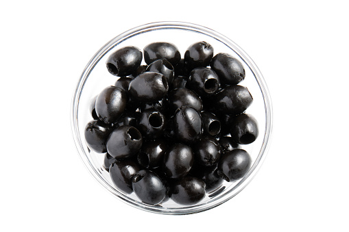 Bowl full of black olives isolated on white top view