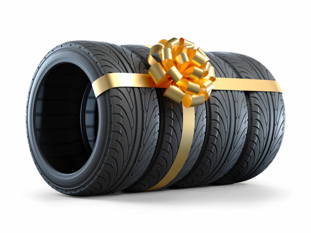 car tires wrapped in a gift ribbon with a bow - car tire red new imagens e fotografias de stock