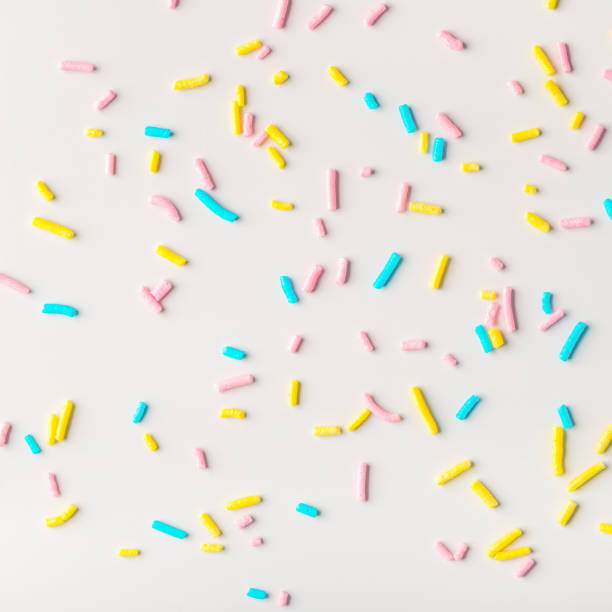 istock colorful sprinkles on white background, flat lay 905679204