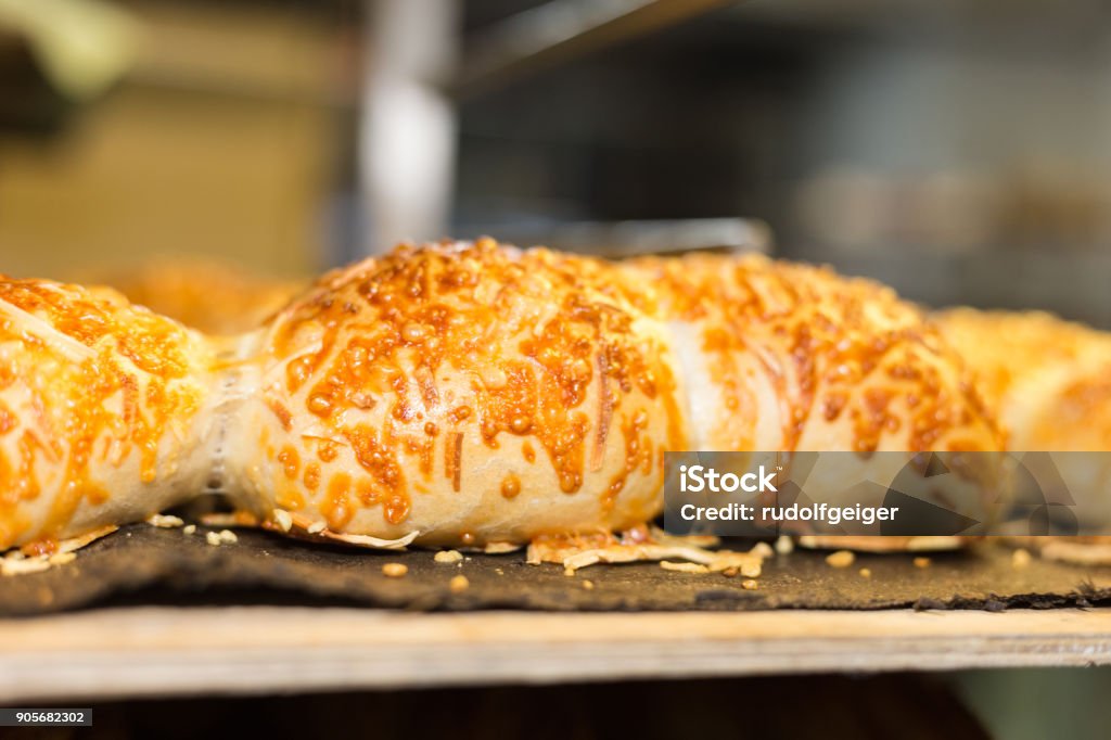 baking pastries and bread in an oven at a bakery baking pastries and bread in an oven with gold brown delicious colors at a bakery in south germany Bagel Stock Photo