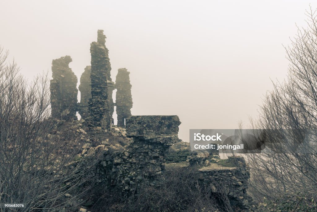 Ancient stone ruins of a fort at Vizzavona in Corsica Ancient stone ruins of a fort at Vizzavona in Corsica shrouded in mist Abandoned Stock Photo