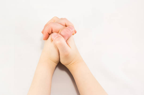 istock photo of praying hands. 905684254