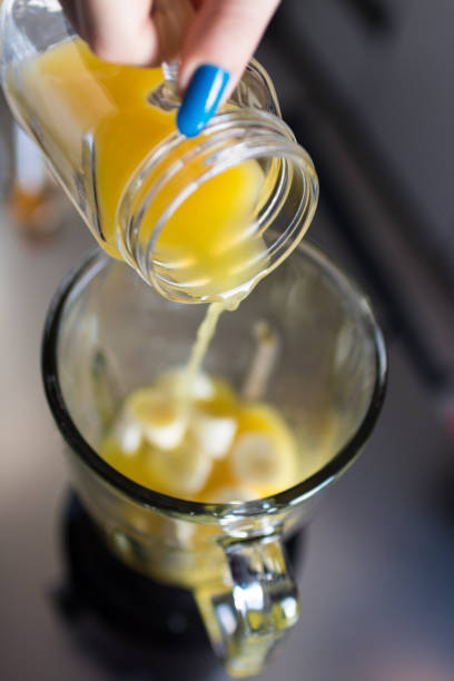istock Adding orange juice to her recipe 905687296