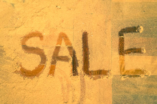 istock Inscription SALE on a wooden floor, small chips. 905689916