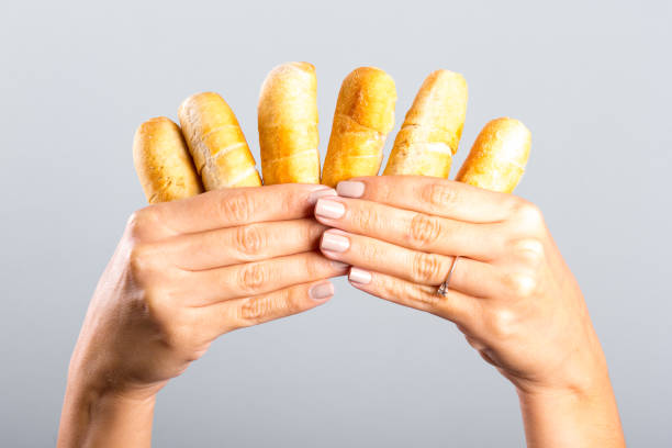 istock woman's hand holding cheese fingers 905694626