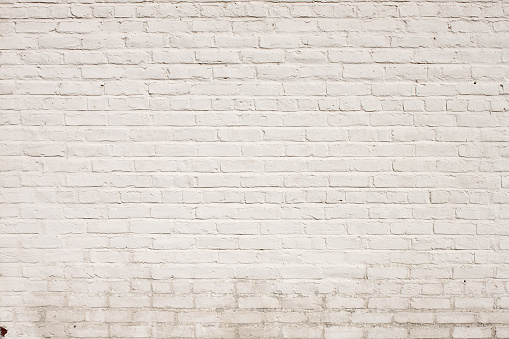This background wallpaper design is a photo of a blank brick wall painted white. You can see some age and mildew at the bottom. There is a grunge feel to this background and is nothing but copy-space and you could superimpose any image on top of it and give it the brick texture.  ’A cool background pattern design, a very Old White Painted Brick wall background texture, great backdrop for an ad or design element wallpaper for a poster. - A great Background Texture Pattern, or Graphic Element Wallpaper for poster design.'