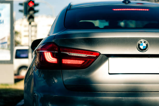 Back of BMW X6 in traffic Back of grey BMW X6 car standing in traffic light bmw stock pictures, royalty-free photos & images