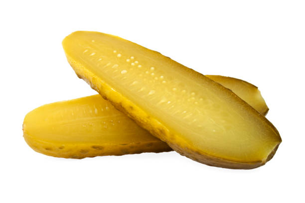 istock One pickled cucumber cut in half on white background 905698820