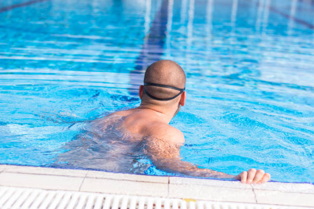 istock Young man on the edge of the pool. 905700410