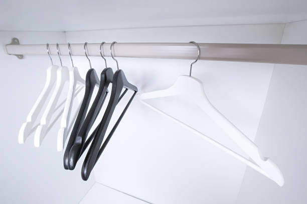 istock White and black empty clothes hangers, in the wardrobe 905706700