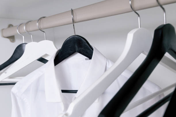 istock White and black empty clothes hangers, in the wardrobe 905706752