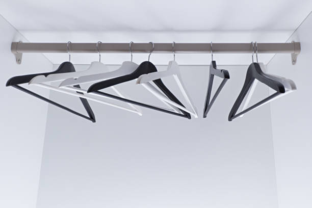 istock White and black empty clothes hangers, in the wardrobe 905706834
