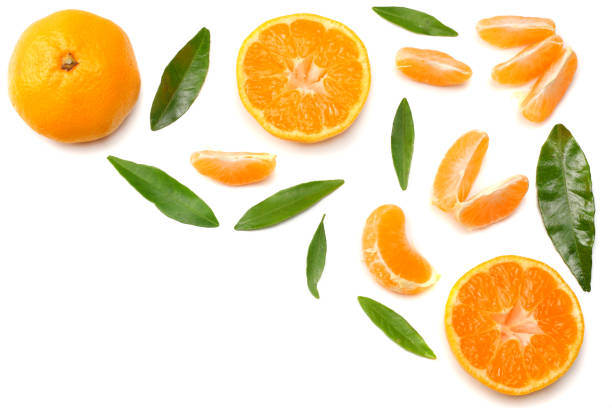 istock mandarin with slices and green leaf isolated on white background top view 905709726