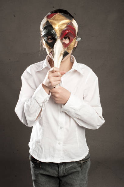 istock little girl holding carnival mask 905713400