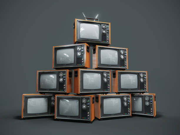 istock Pile of old retro TVs on dark background 905715128