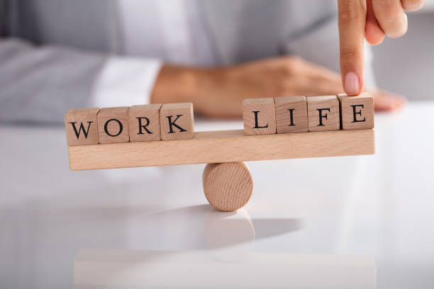 istock Businessperson's Finger Showing Imbalance Between Work And Life 905715398