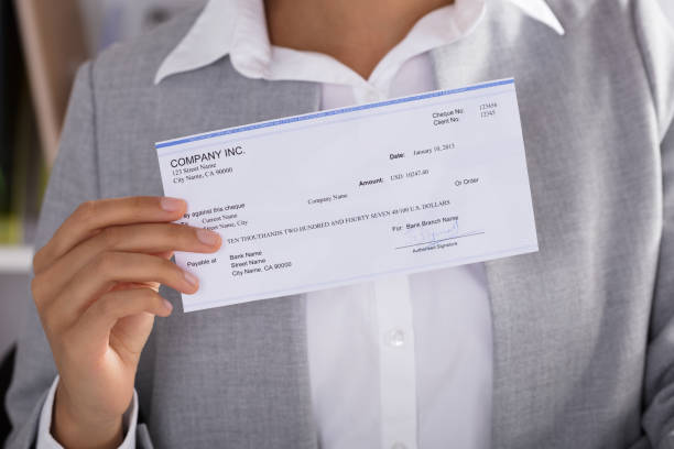 Businesswoman Showing Cheque Midsection Of Businesswoman Showing Cheque At Office bowie seamount stock pictures, royalty-free photos & images