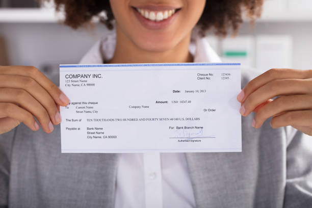 Businesswoman Showing Cheque Midsection Of Businesswoman Showing Cheque At Office bowie seamount stock pictures, royalty-free photos & images