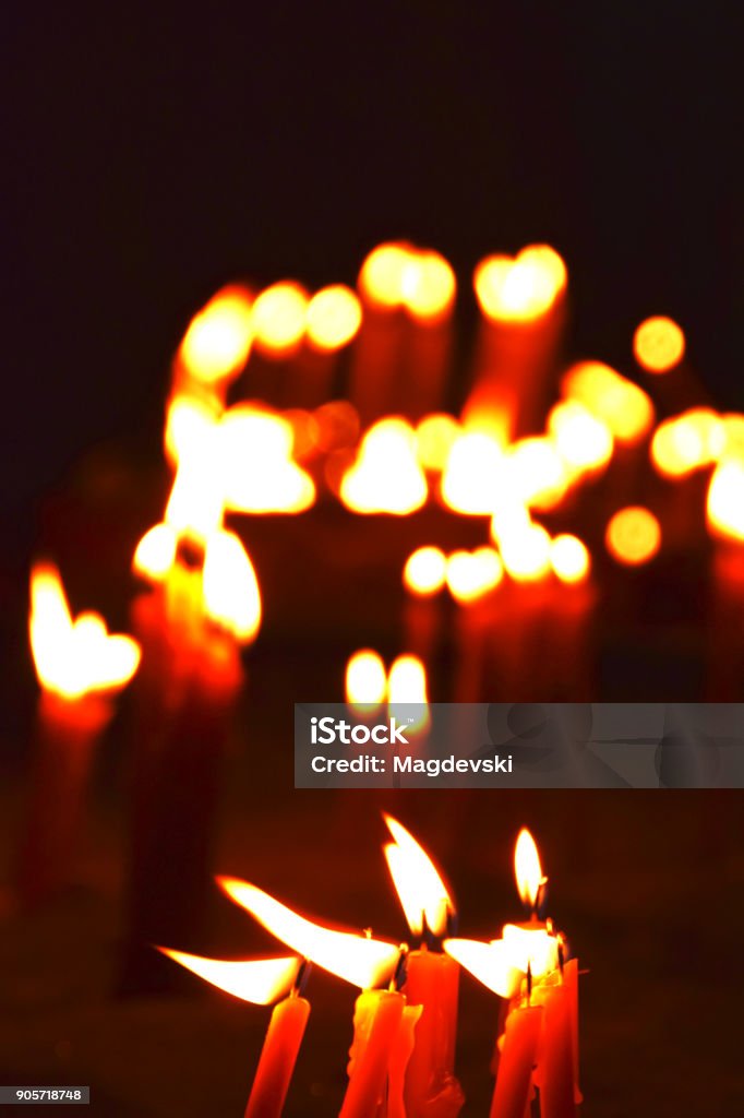 burning candles on a candle stand in the church Ancient Stock Photo