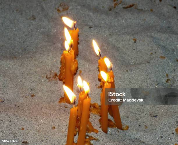 Burning Candles In A Sand On A Candle Stand In The Church Stock Photo - Download Image Now