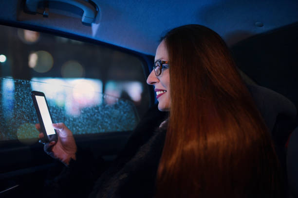 istock Business woman using smartphone in the car 905719144
