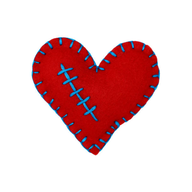 istock Close up one red felt heart isolated on white 905726554