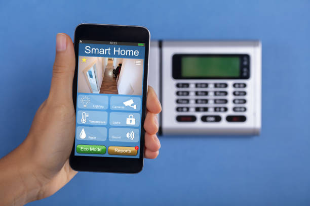 istock Person Holding Mobile Phone With Home Security Application 905726900