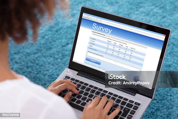 Woman Filling Survey Form On Laptop Stock Photo - Download Image Now - Questionnaire, Internet, Computer