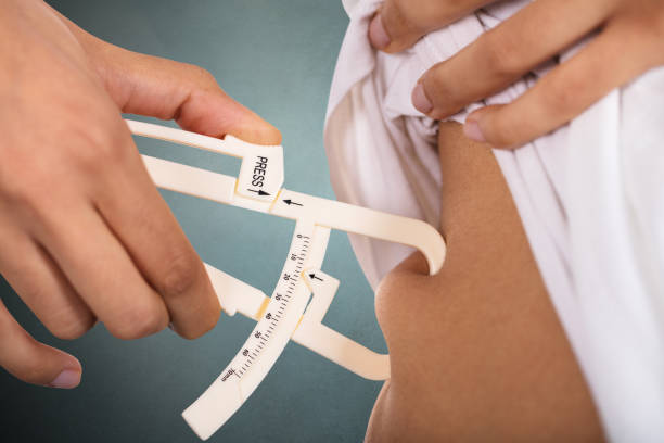 Woman Checking Stomach Fat With Caliper Close-up Of A Woman's Hand Checking Stomach Fat With Caliper caliper photos stock pictures, royalty-free photos & images