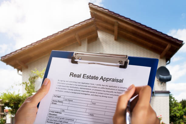 istock Person Filling Real Estate Appraisal Form 905727010