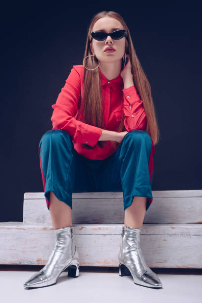 istock girl in red shirt sitting on stairs 905727794