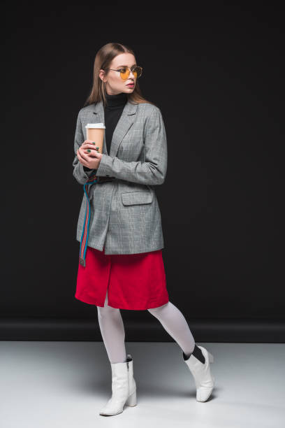 istock woman with coffee in paper cup 905728318