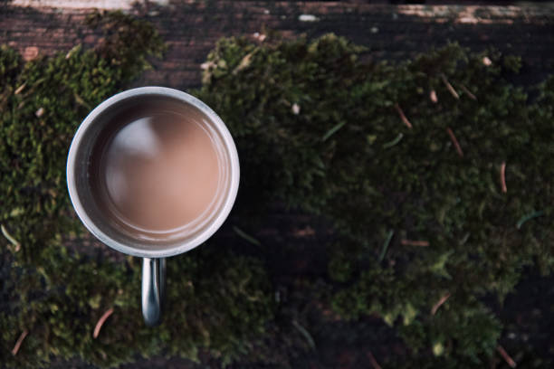 istock Coffee cup on old wooden table outdoors 905728388