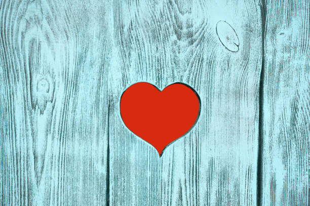 istock Red heart carved in a wooden board. Background 905730728