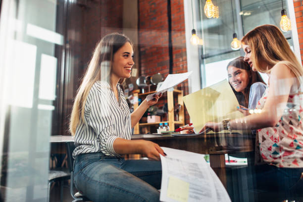 istock College female students sitting at table working on school assignment in a library 905730804