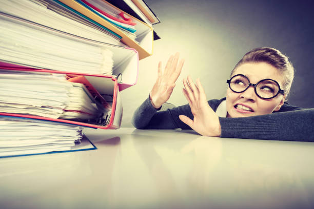 istock Accountant terrified of pils of binders. 905734170