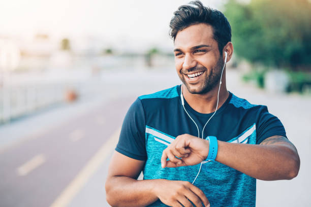 istock Smiling young athlete with smart watch 905746170