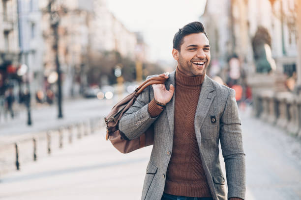 istock Elegant young man with a bag on the street 905746172