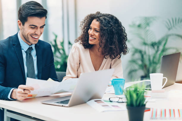 Couple of business persons on a meeting Multi-ethnic group of people on a business meeting businesswear stock pictures, royalty-free photos & images