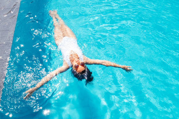 istock Woman relax in swim pool. Luxury resort vacation 905746830