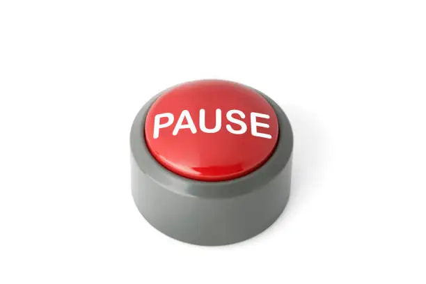 Photo of Red Circular Push Button Labeled 'Pause' on White Background