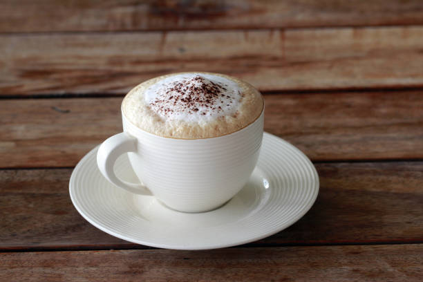 istock hot cappuccino  coffee in cup on the wooden table 905754282