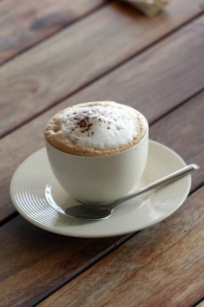 istock hot cappuchino coffee in cup on the wooden table 905754316