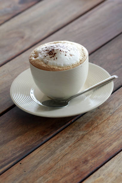 istock hot cappuchino coffee in cup on the wooden table 905754322