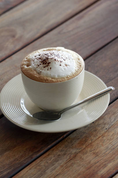 istock hot cappuchino coffee in cup on the wooden table 905754414