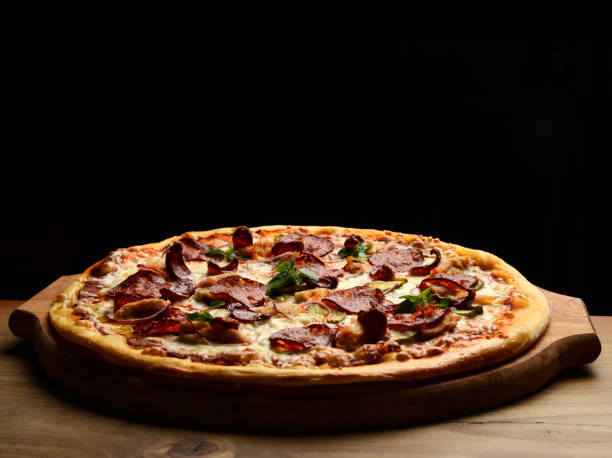 Pizza composition with melting cheese bacon tomatoes ham paprika stock photo