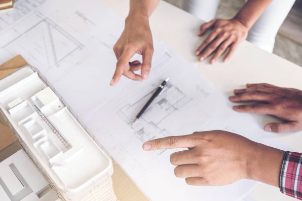istock Architect working on blueprint, Engineer meeting working with partner colleagues and engineering tools for architectural project, Construction concept 905768698