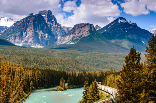 istock Rocky Mountains, blue sky and stormy river streams 905771338