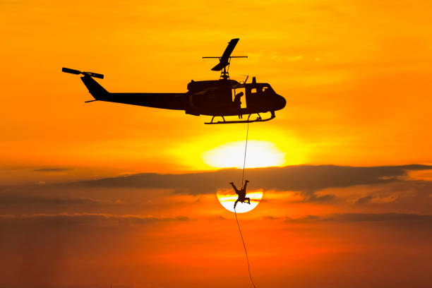 istock Soldiers rescue helicopter operations on sunset sky background 905771656
