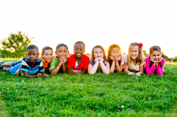 istock Kids Laying In The Grass 905774984
